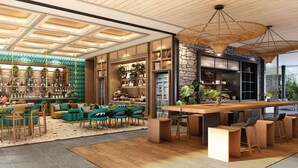 A spacious interior with a long wooden bar, seating areas, and a variety of plants. - Montazure Resort Phuket - Mgallery Collection (Kamala)