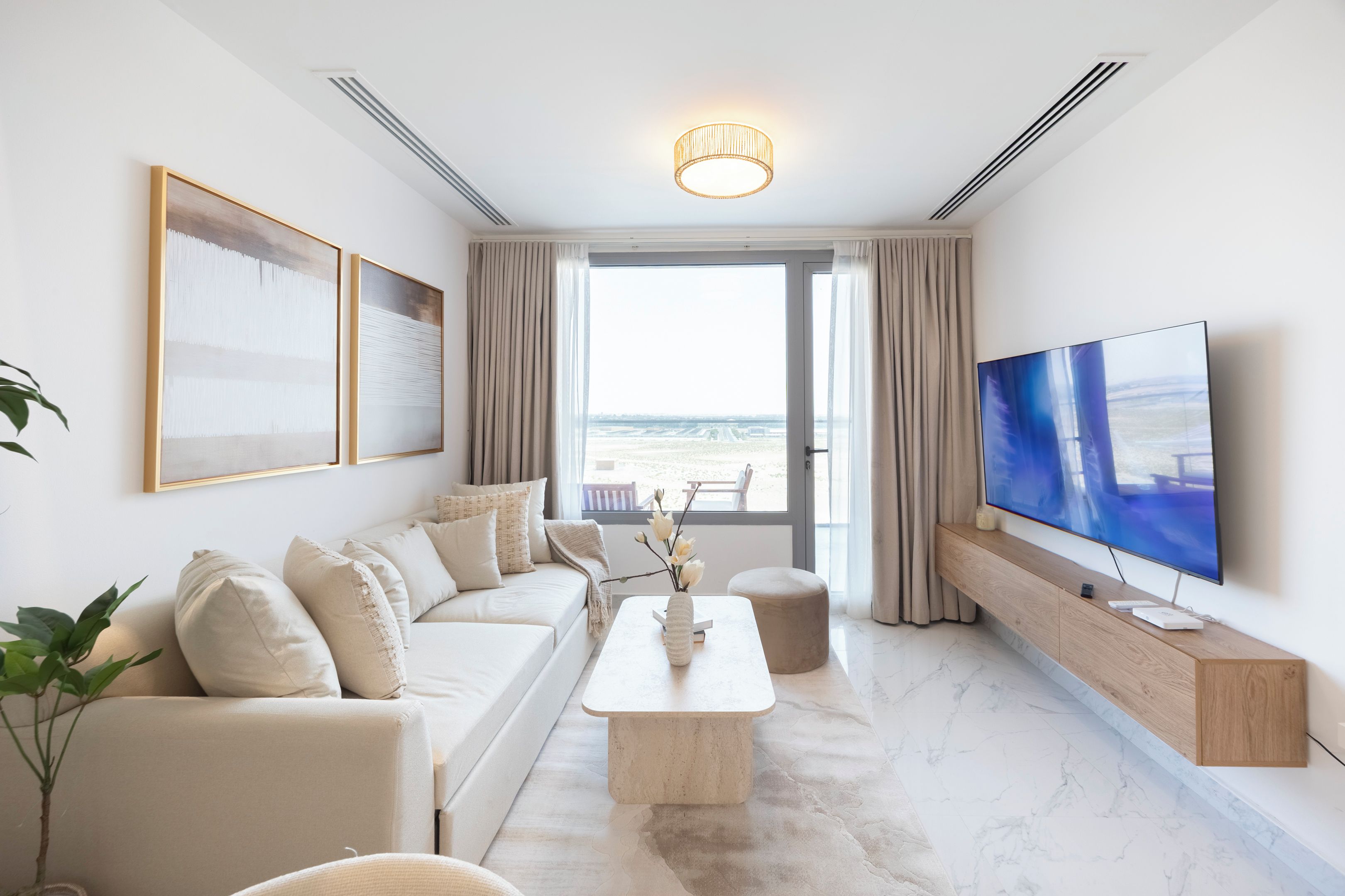 A modern living room with a sofa, coffee table, and TV.