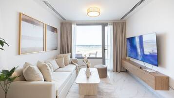 A modern living room with a sofa, coffee table, and TV.
