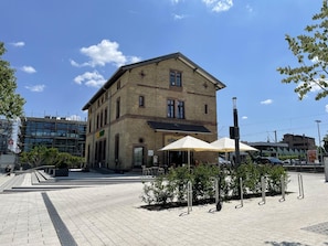 A two-story building with a stone facade, a flat roof, and a large window on the second floor. - Hotel am Bahnhof Stuttgart-ditzingen (Ditzingen)