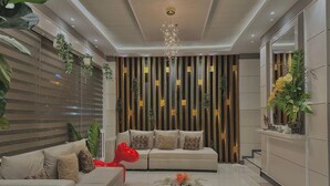 A modern living room with a sofa set, a coffee table, and decorative plants. - Central Block Inn (Bacolod)