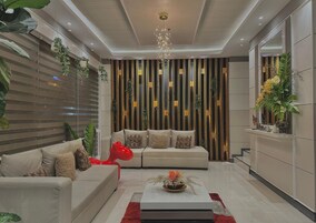 A modern living room with a sofa set, a coffee table, and a decorative red sculpture.