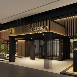 Facciata moderna di un edificio con la scritta ben visibile 'ANCHORED by RIHGA'.