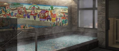 Zona de spa con un gran mural, una bañera de hidromasaje y una pared de piedra.