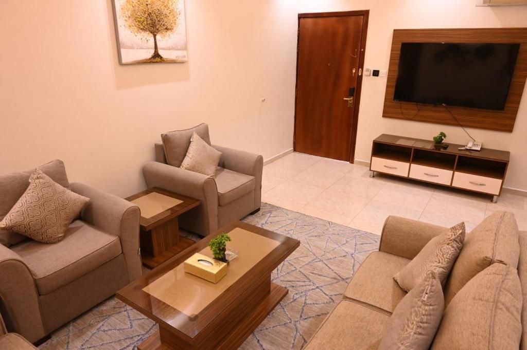 A living room with two sofas, a coffee table, a TV, and a cabinet.