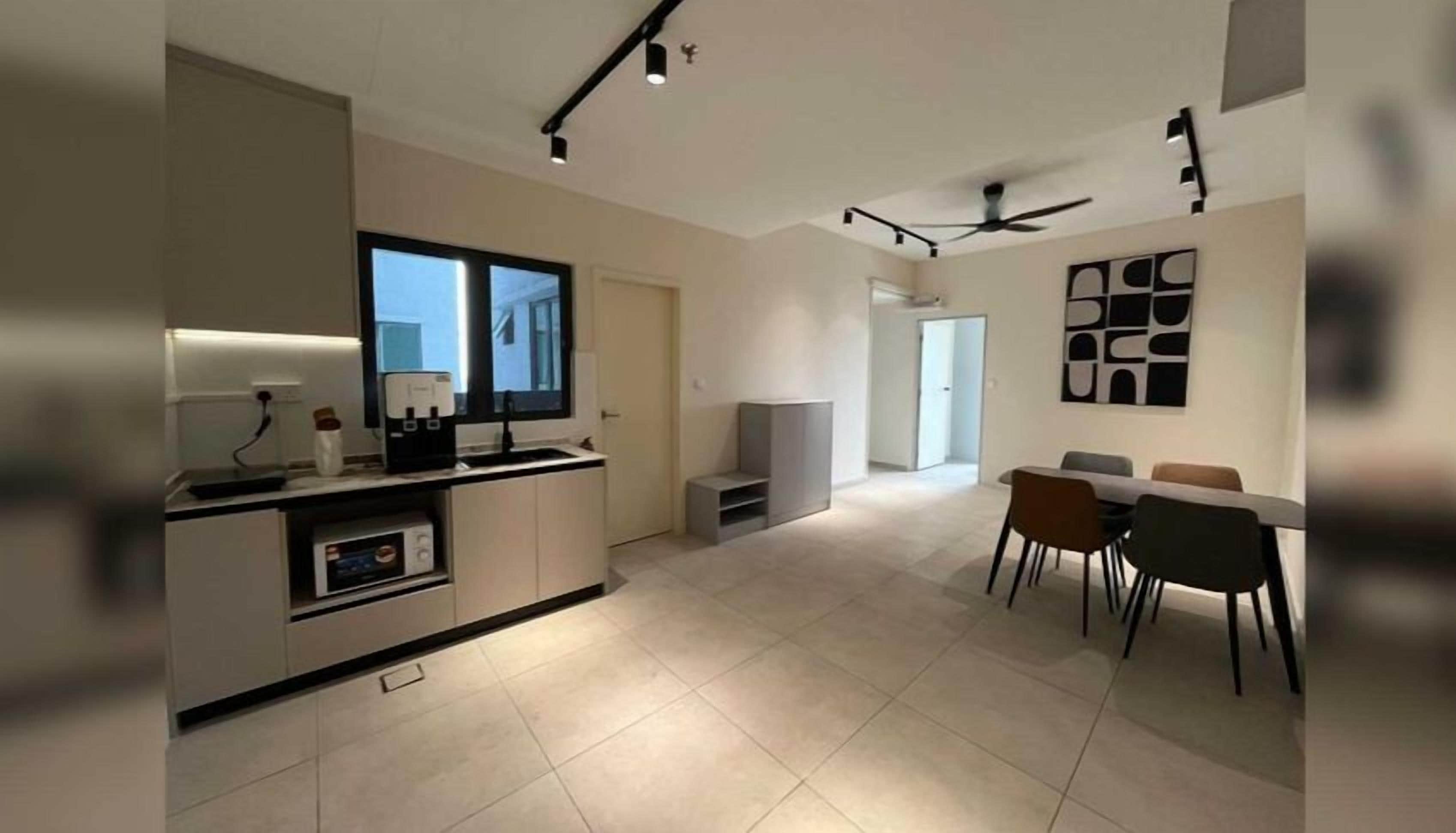 A modern kitchen with a dining area, a ceiling fan, and a view of the outside.