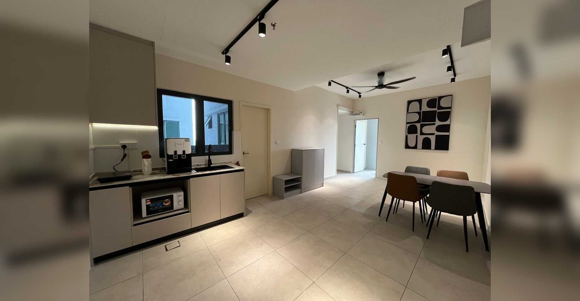A modern kitchen with a built-in oven, a dining area with a table and chairs, and a ceiling fan.