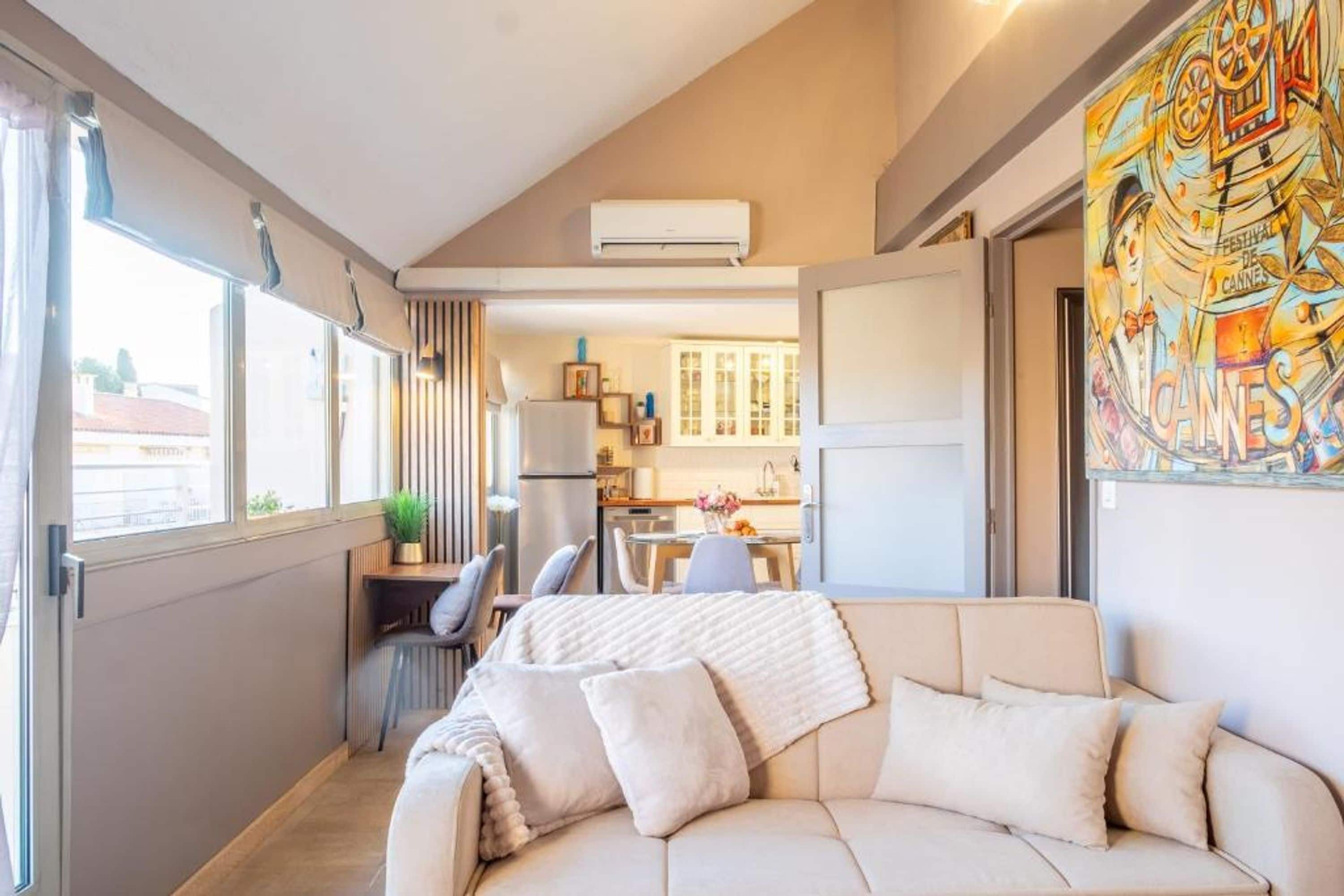 Un espacio habitable compacto con sofá, comedor y cocina.