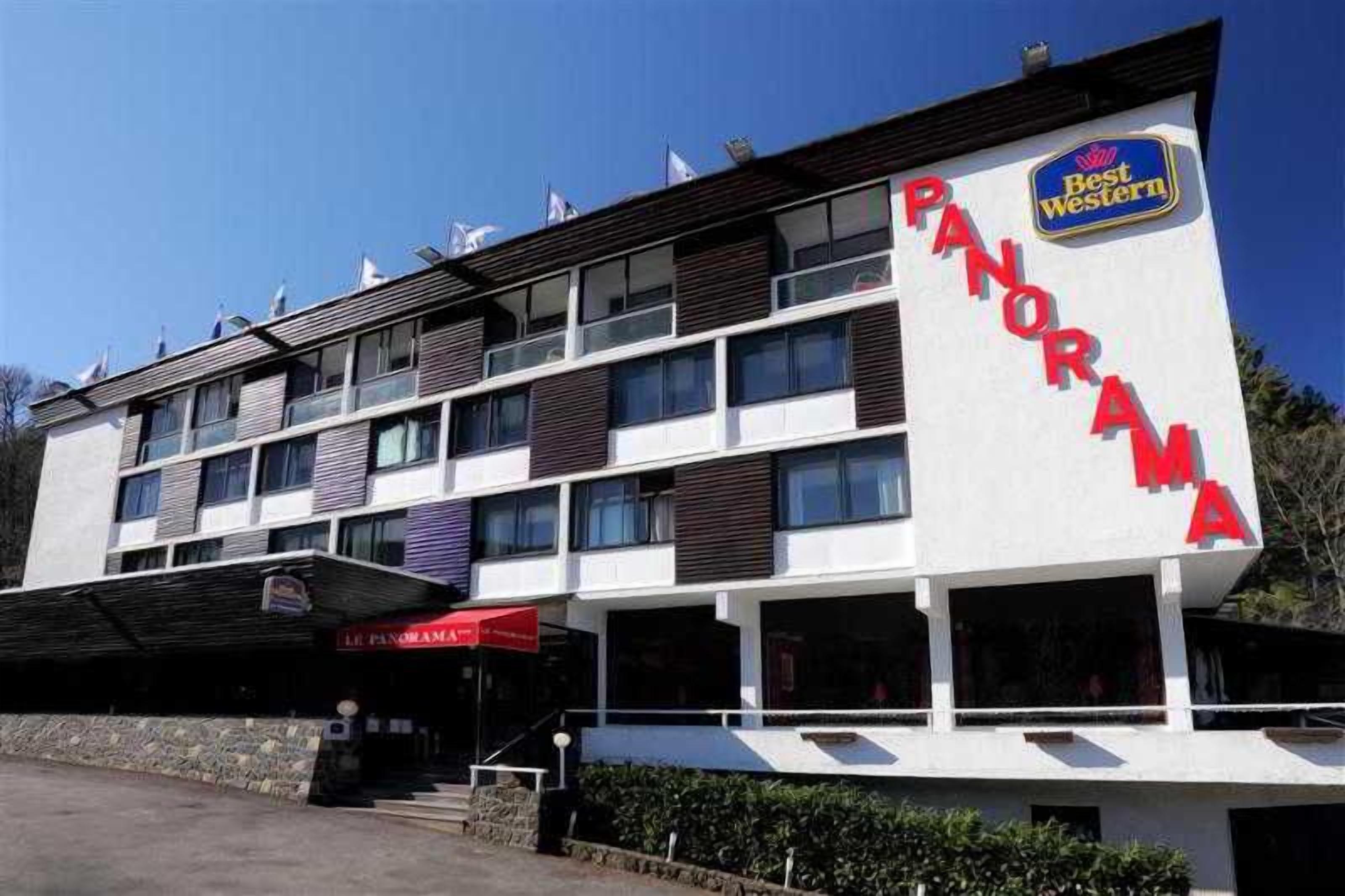 A multi-story hotel with a prominent 'PANORAMA' sign, indicating a view of the surrounding area.