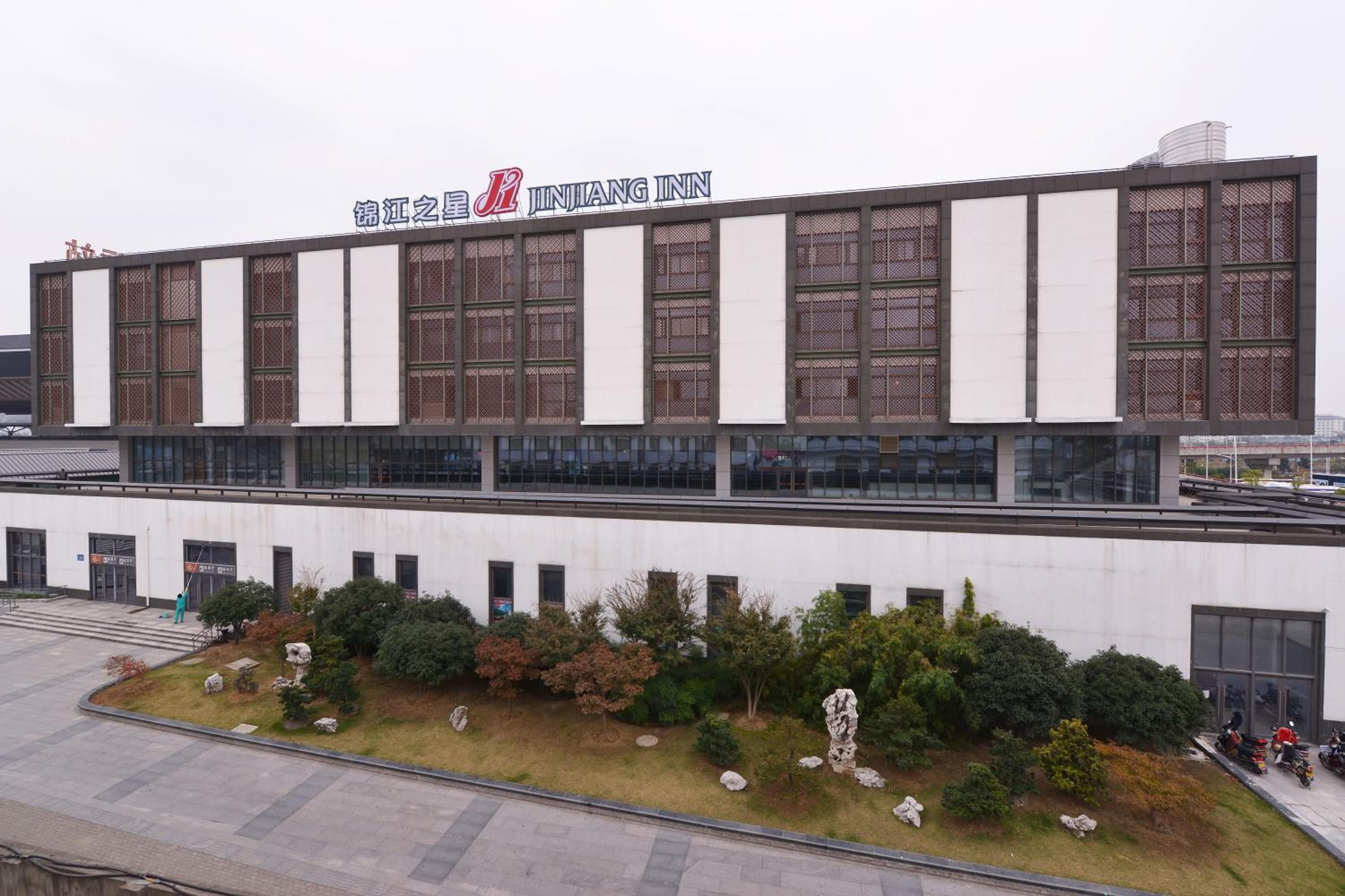A modern building with a sign reading 'JINJANG INN'.