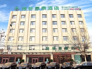 A multi-story hotel building with a prominent sign at the top.