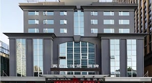 A modern hotel building with a prominent entrance, large windows, and a sign indicating it is a Borman hotel. - Borrman Wanda Plaza Houjie Dongguan (Dongguan)