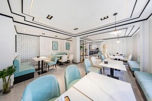 A modern restaurant interior with a brick wall, seating arrangements, and a visible kitchen area. - Lavande Hotel (Tianjin)