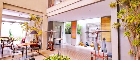 A spacious lobby with a seating area, a staircase, and a view of the outdoors.