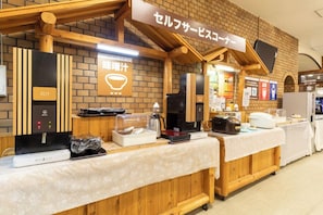 A buffet setup with a coffee station and a sign indicating a self-service area. - Izunagaoka Onsen Kobo no Yu Nagaokaten (Izunokuni)