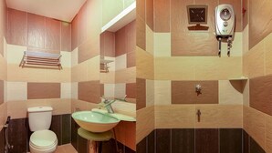 A bathroom with a toilet, sink, and shower area. - OYO 43930 Hotel Esplanade (Sandakan)