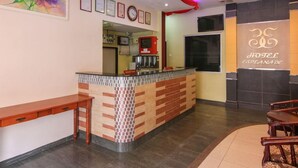 A hotel reception area with a reception desk, framed certificates on the wall, and a logo on the wall. - OYO 43930 Hotel Esplanade (Sandakan)