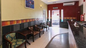 A hotel lobby with a reception desk, seating area, and a view of the street. - OYO 43930 Hotel Esplanade (Sandakan)