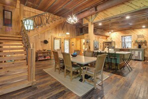 A rustic wooden interior with a dining area, kitchen, and staircase. - Seven Feathers A Modern Barn Retreat/ Pet & Family Friendly (Blue Ridge)