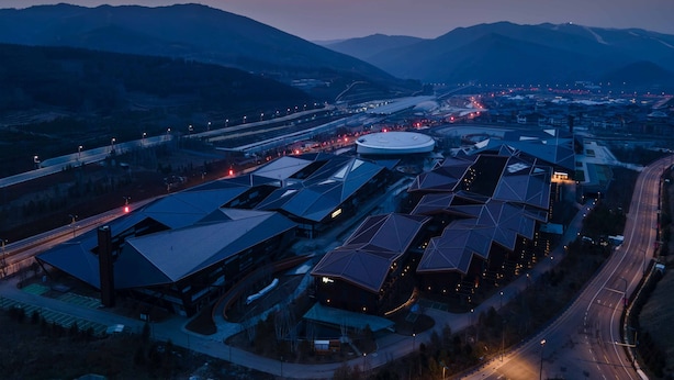 A modern building complex with multiple structures, including a large circular building and several smaller ones with unique roof designs. - Even Hotel Chongli (Zhangjiakou)