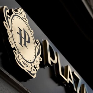 A building sign with a prominent letter 'P' and the word 'PLAZA' in a stylized font. - Plaza Boutique Hotel Prishtina (Pristina)