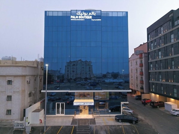 A modern building with a glass facade and a reception area at the ground level. - Palm Boutique Hotel Al Salamah (Jeddah)