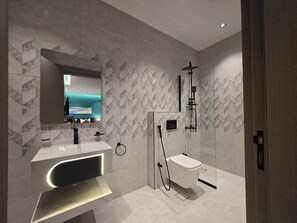 A modern bathroom with a built-in sink, a toilet, and a shower area. - Palm Boutique Hotel Al Salamah (Jeddah)