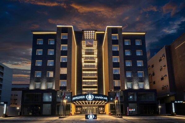 A hotel with a modern facade, multiple floors, and a central entrance with illuminated signage. - Gardn Millennium Al-salamah Hotel Jeddah (Jeddah)