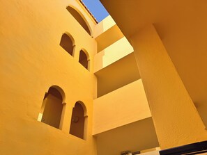 A multi-level building with a yellow facade and multiple arches. - Beachfront • Sea Views • The Mimosas • La Cala de Mijas (La Cala de Mijas)