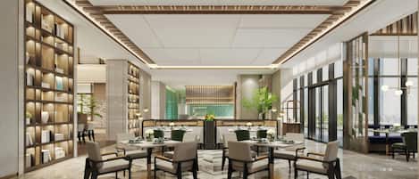 A modern hotel lobby with a central dining area, a reception desk, and a large bookshelf.