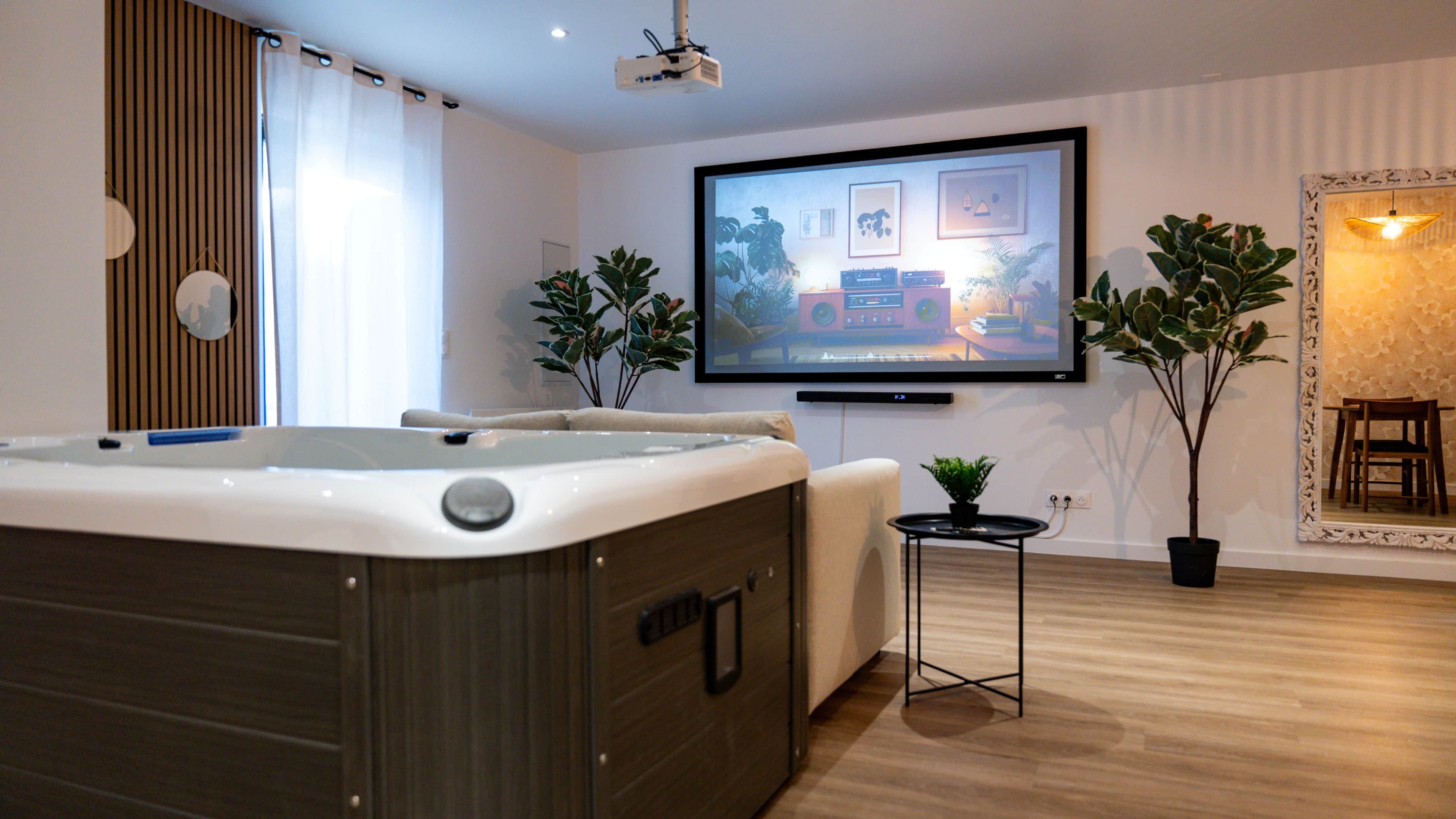 A modern living room with a large flat-screen TV, a hot tub, and two potted plants.