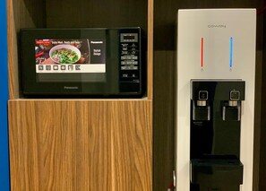 A microwave with a digital display and a water dispenser with temperature settings. - Airdence (Kota Kinabalu)