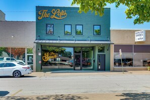 A storefront with a sign reading 'The Loft' and a smaller sign for 'Hamilton Shoes and Repair' across the street. - Walk to Mountain Home Square: Remodeled Apt (Mountain Home)