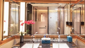 A modern bathroom with a large mirror, two sinks, a shower, and a potted plant. - Grand Skylight InternationalHotelXinfeng (Ganzhou)