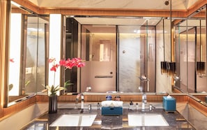 A modern bathroom with a large mirror, two sinks, a shower, and a potted plant. - Grand Skylight InternationalHotelXinfeng (Ganzhou)