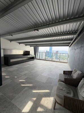 A spacious balcony with a city view, a sofa, and a built-in bench. - Skyline A-36-01, heart of the city with car park (Kuala Lumpur)