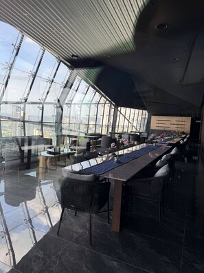 A modern interior with a large glass window, a long dining table, and black chairs. - Skyline A-36-01, heart of the city with car park (Kuala Lumpur)