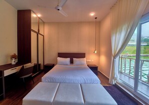 A hotel room with a bed, a desk, a chair, a nightstand, and a window with a view of a balcony.