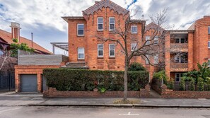 A multi-story brick building with a symmetrical facade, multiple windows, and a central entrance. - Brighton Vale, St. Kilda (St Kilda)