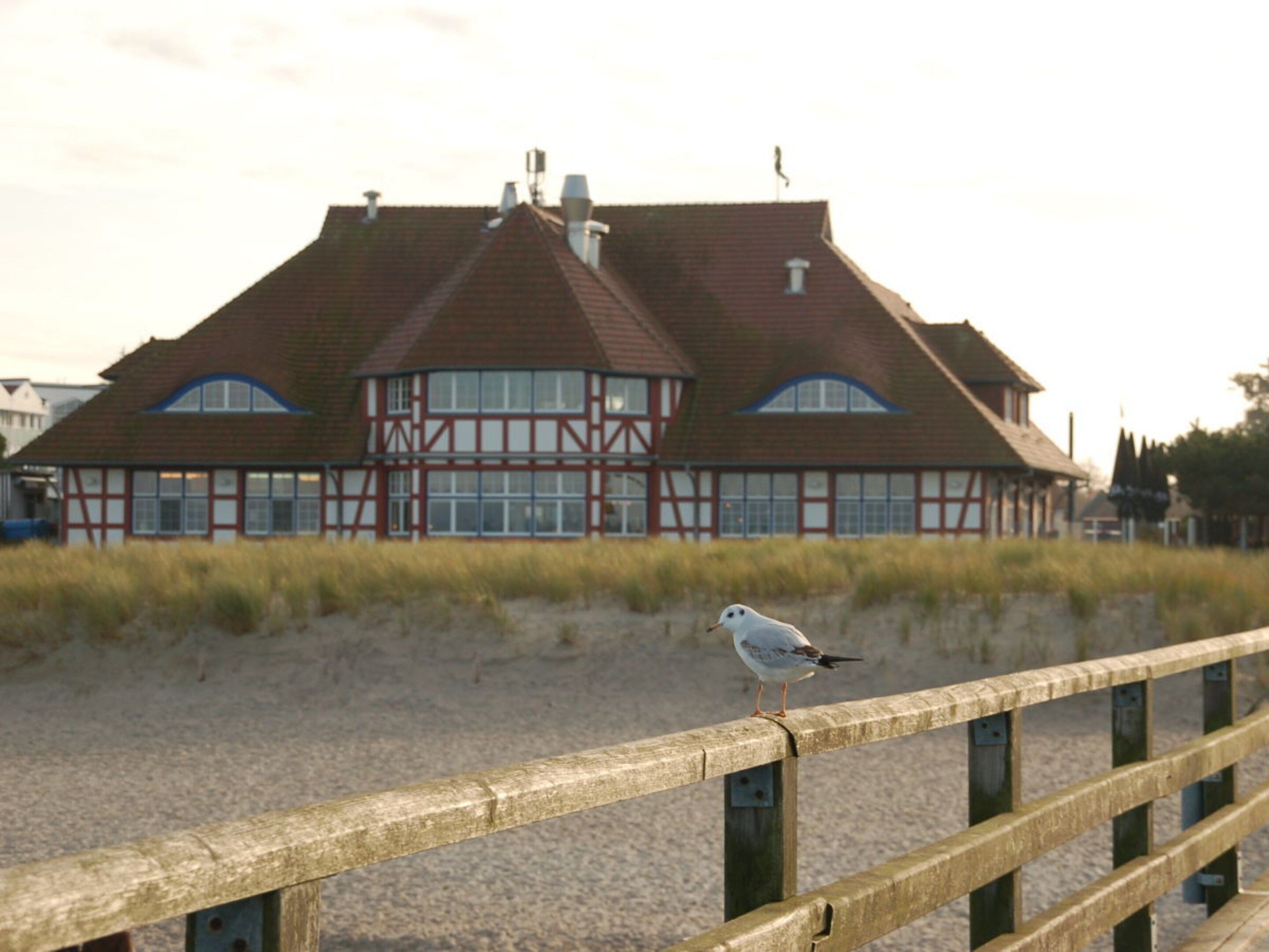 A building with a traditional architectural style, featuring a prominent gabled roof and large windows.