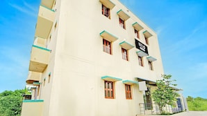 A multi-story hotel building with a sign indicating it is a hotel. - Deluxe KS Comfort (Chidambaram)