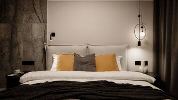 A modern bedroom with a stone wall, a bed with multiple pillows, a bedside table with a lamp, and a hanging light fixture.