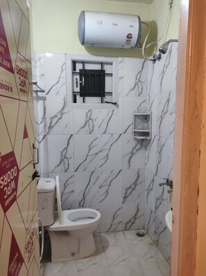 A bathroom with a toilet, a shower, and a water heater. - VISA HOMESTAY
Private Cottage @ Your Budget
family-friendly and pet-friendly (Kodaikanal)