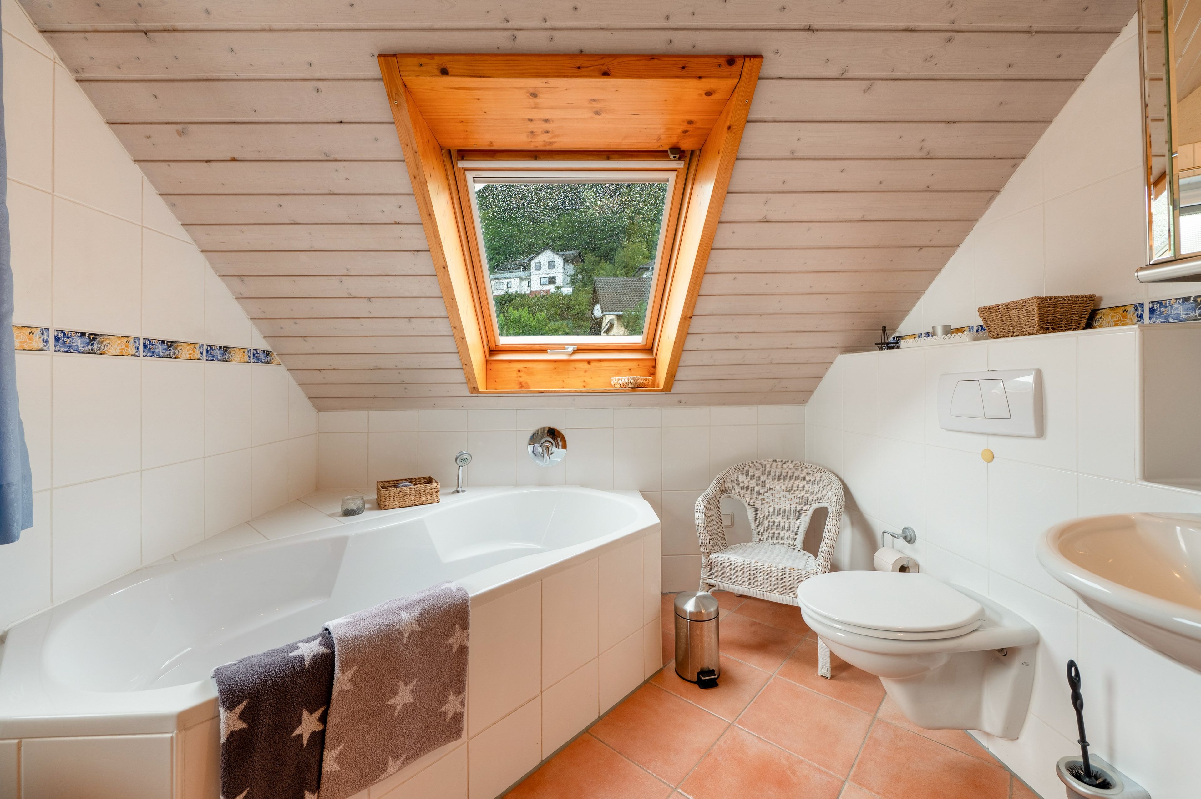 A bathroom with a freestanding bathtub, a toilet, and a sink.