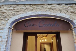An entrance to a building with a sign that reads 'Can Costals.' - Can Costals Olivo in Pals (Masos de Pals)
