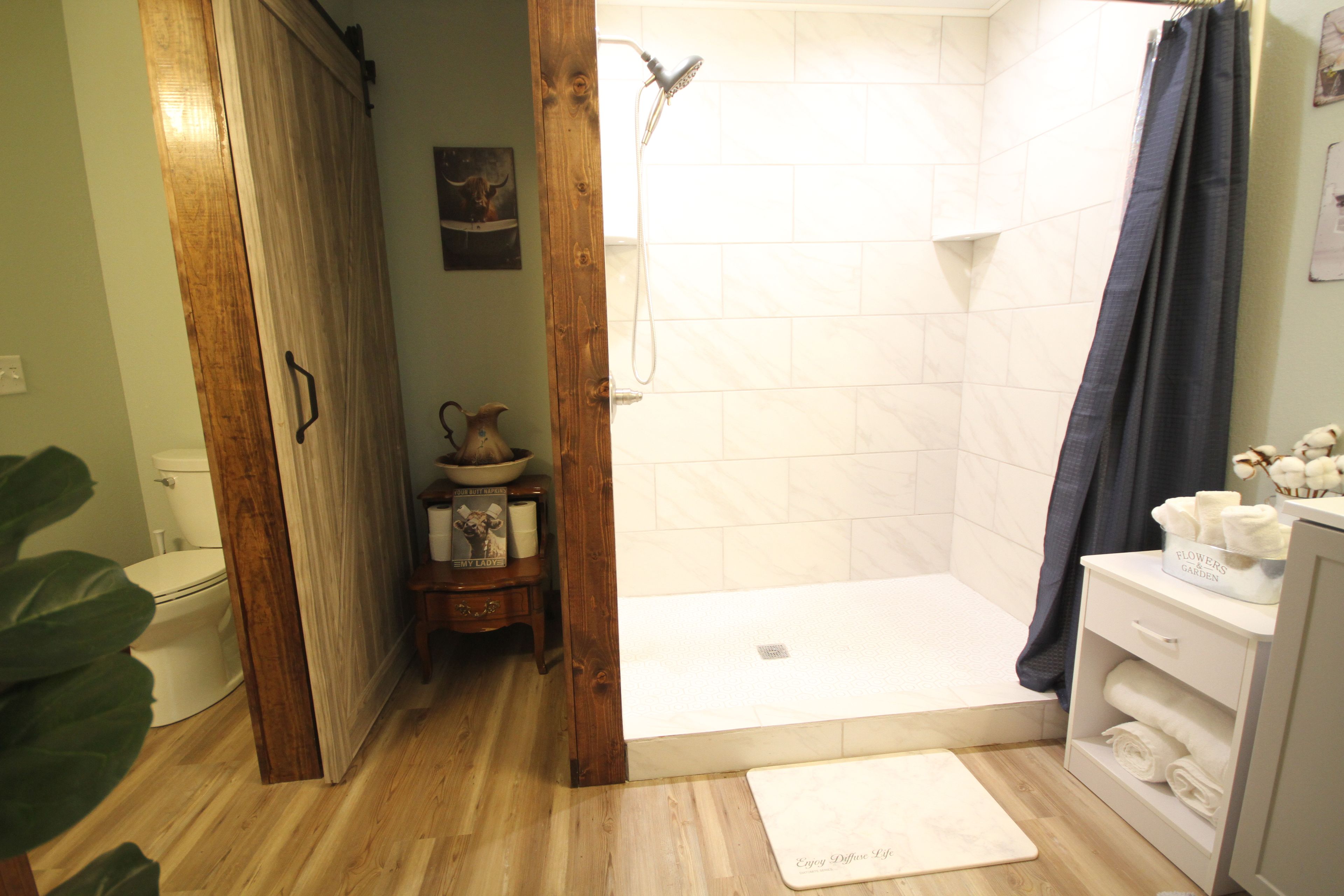 A bathroom with a shower, toilet, and sink.