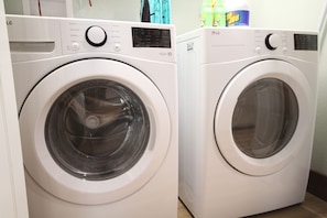 Two front-loading washing machines in a laundry room.