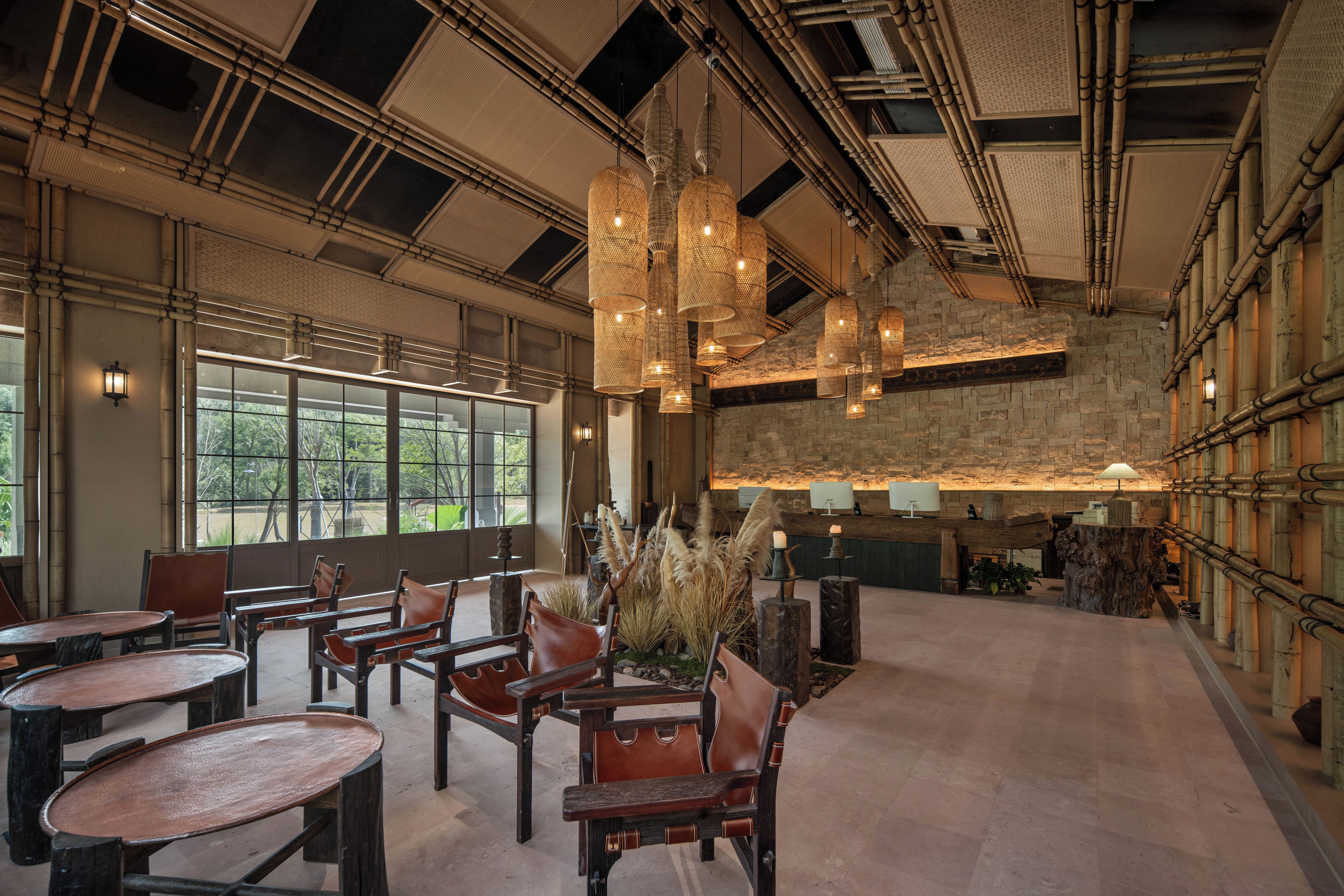 A spacious interior with high ceilings, exposed beams, and a mix of natural and artificial lighting.