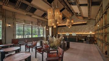 A spacious interior with high ceilings, exposed beams, and a mix of natural and artificial lighting.