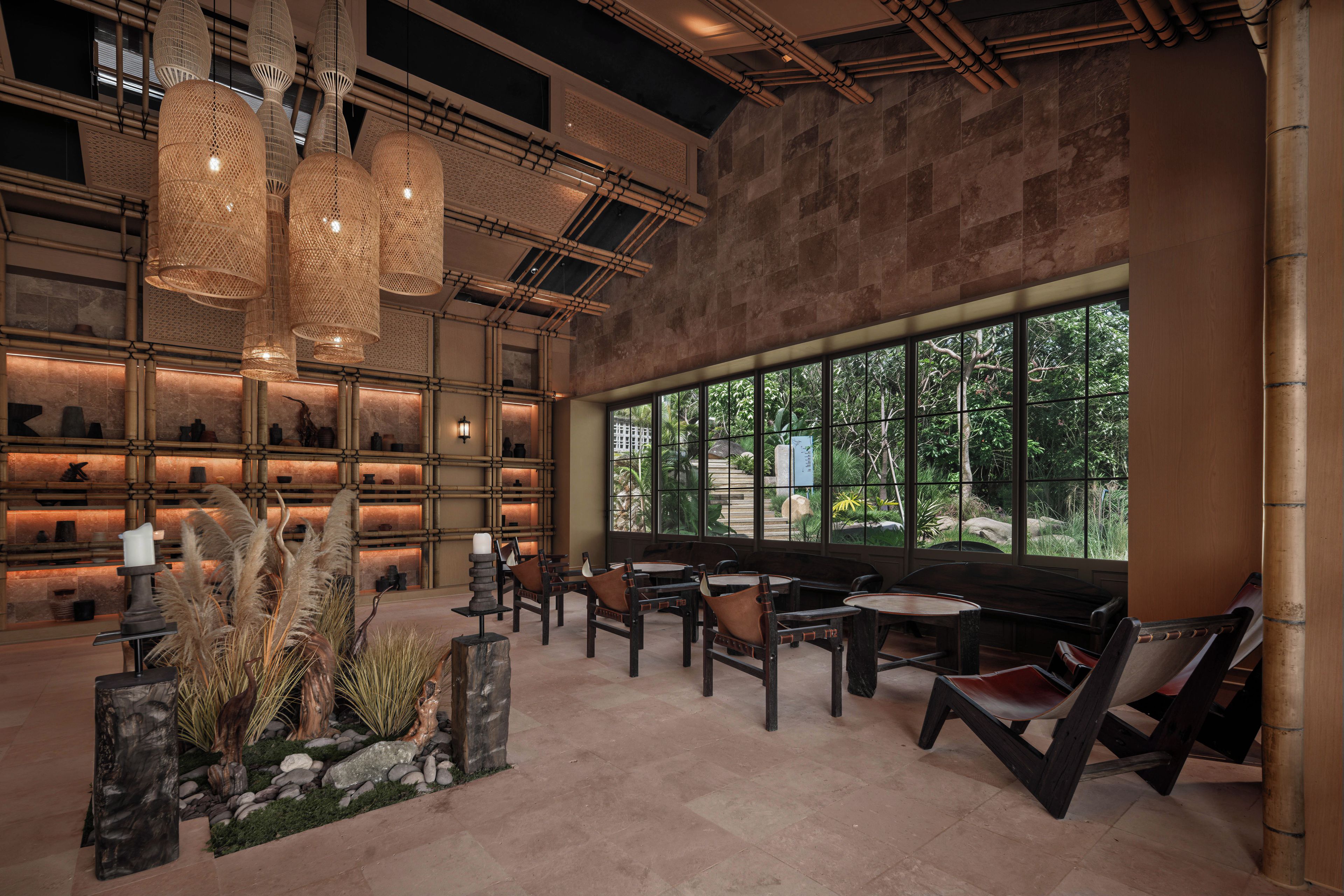A spacious interior with a large window, bamboo elements, and a seating area.